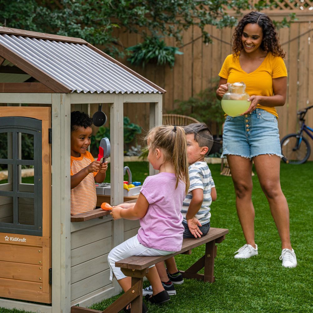 KidKraft Pioneer Cottage Wooden Playhouse - Outdoor Toy for Kids, Playhouse with Porch